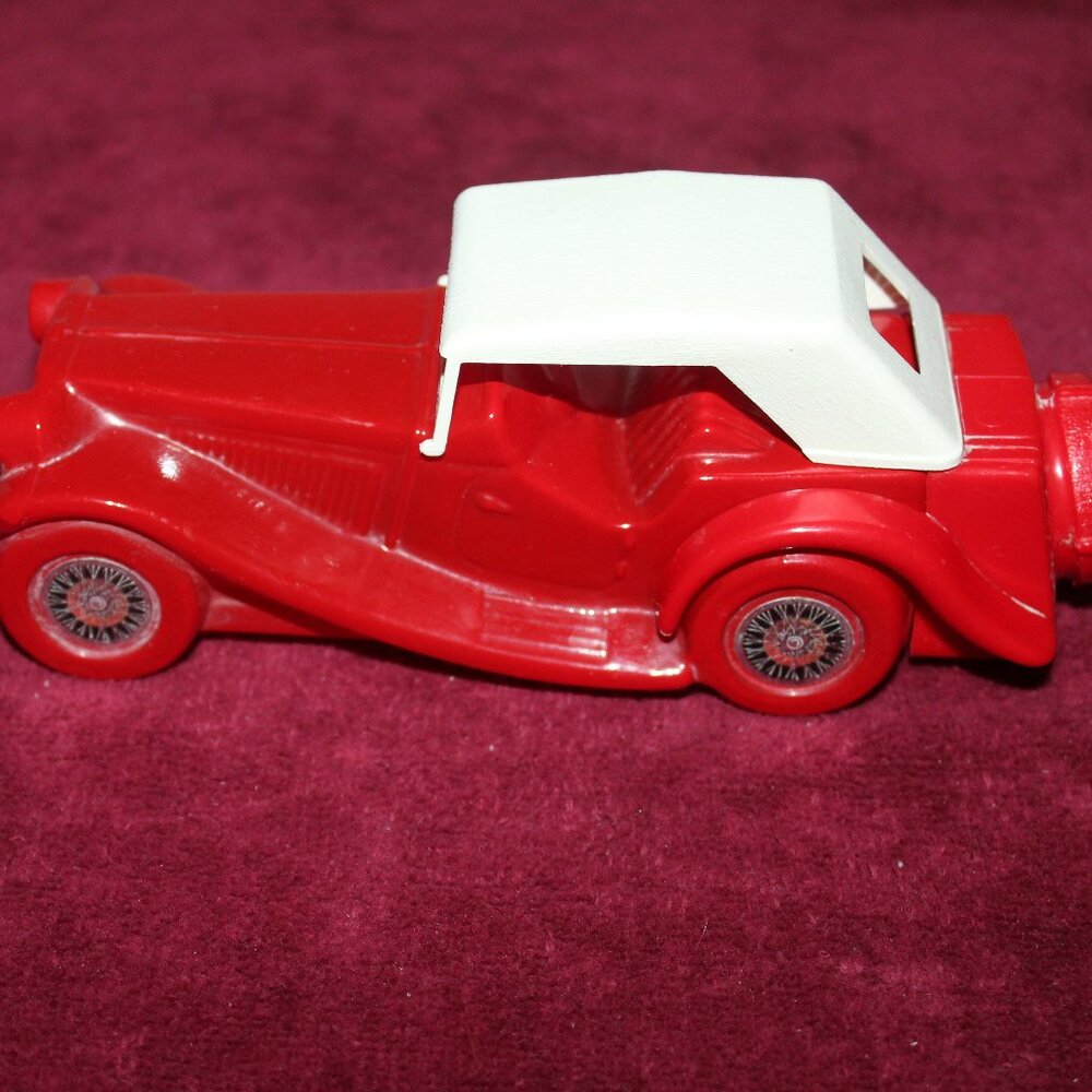 Avon collectible decanter shaped as a red 1936 MG Roadster with a white hardtop